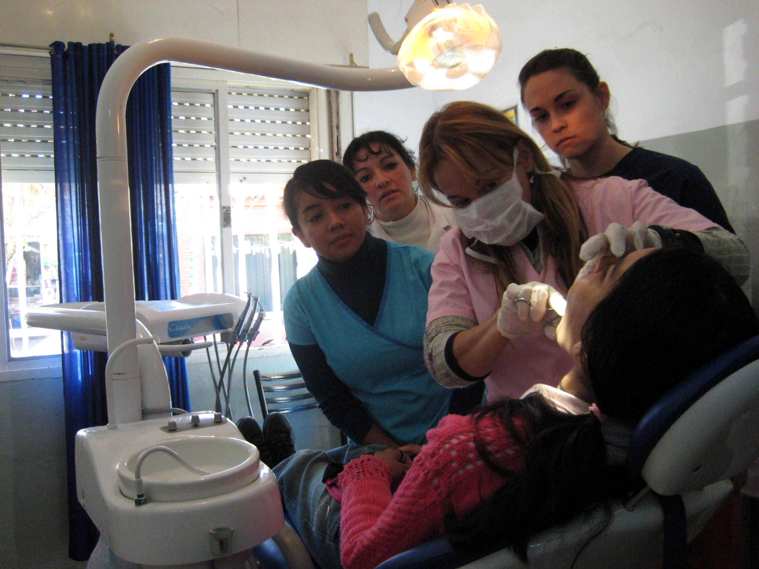 A group of Medical workers examine a patients mouth in a healthcare centre during their Dentistry placements in Argentina. Projects Abroad Dentistry staff learn how to examine the patients mouth during Dentistry internships in Argentina.